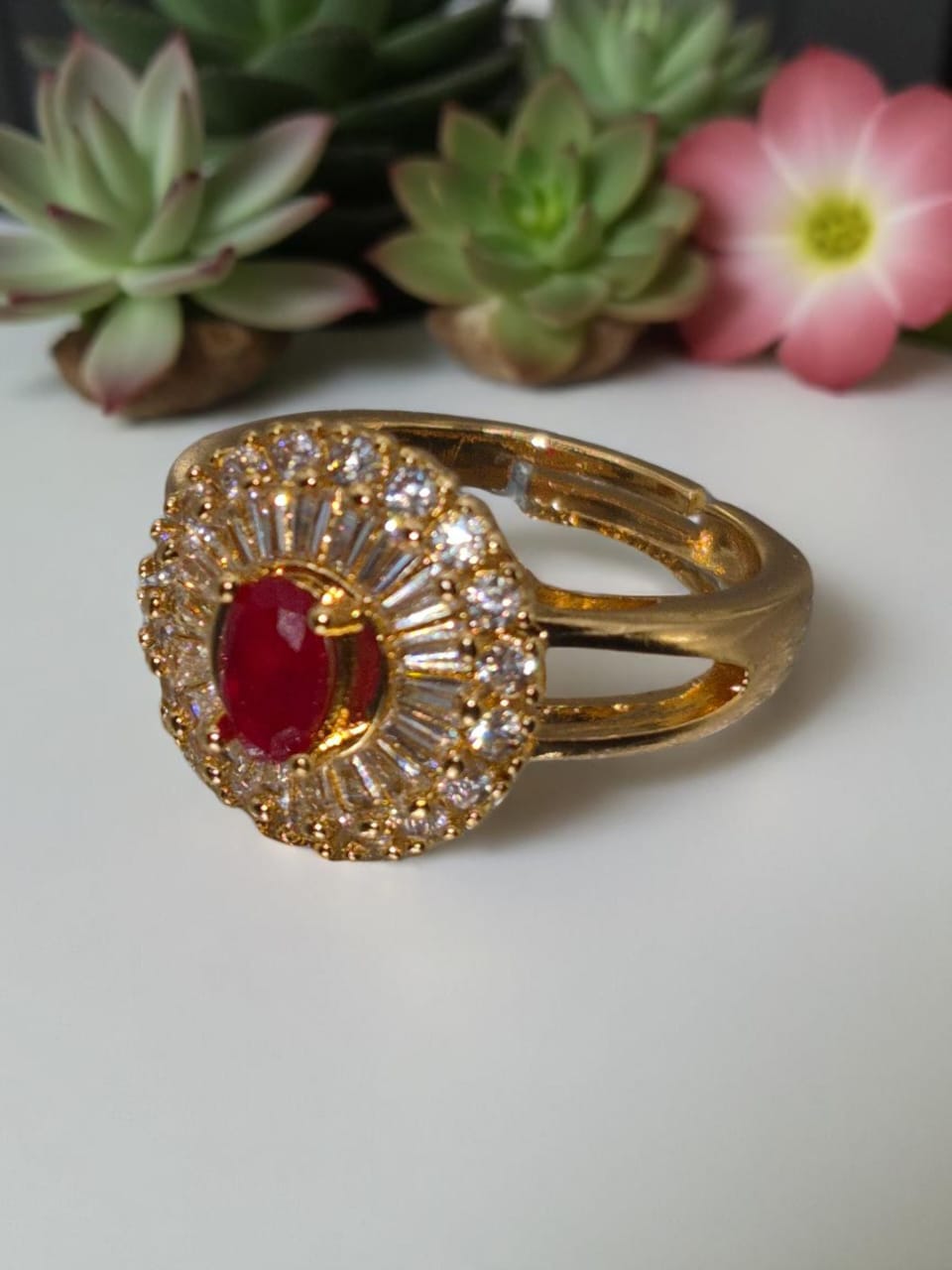 Golden adjustable ring with ruby inside