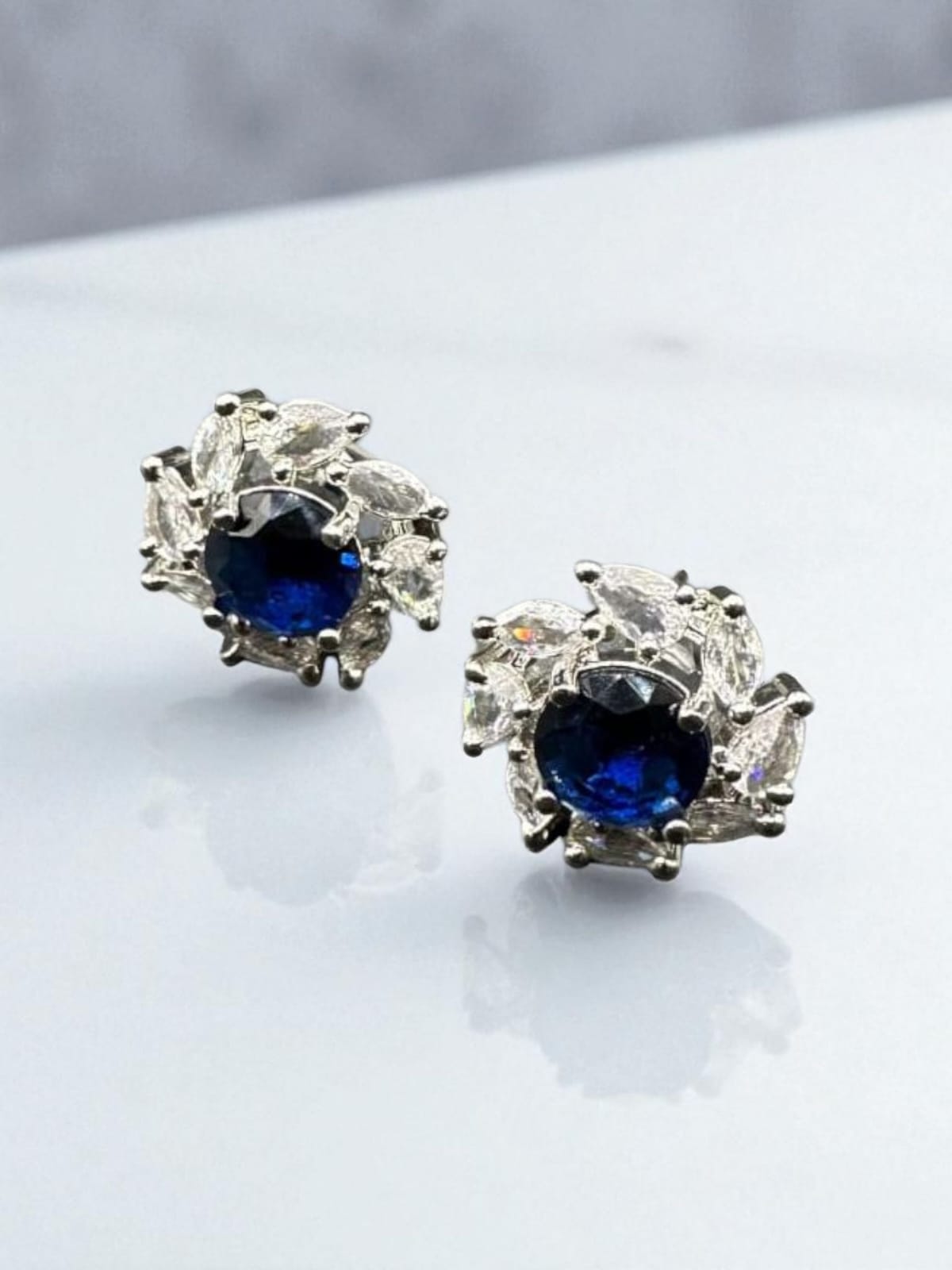 Diamond cut zircon studs with sapphire inside