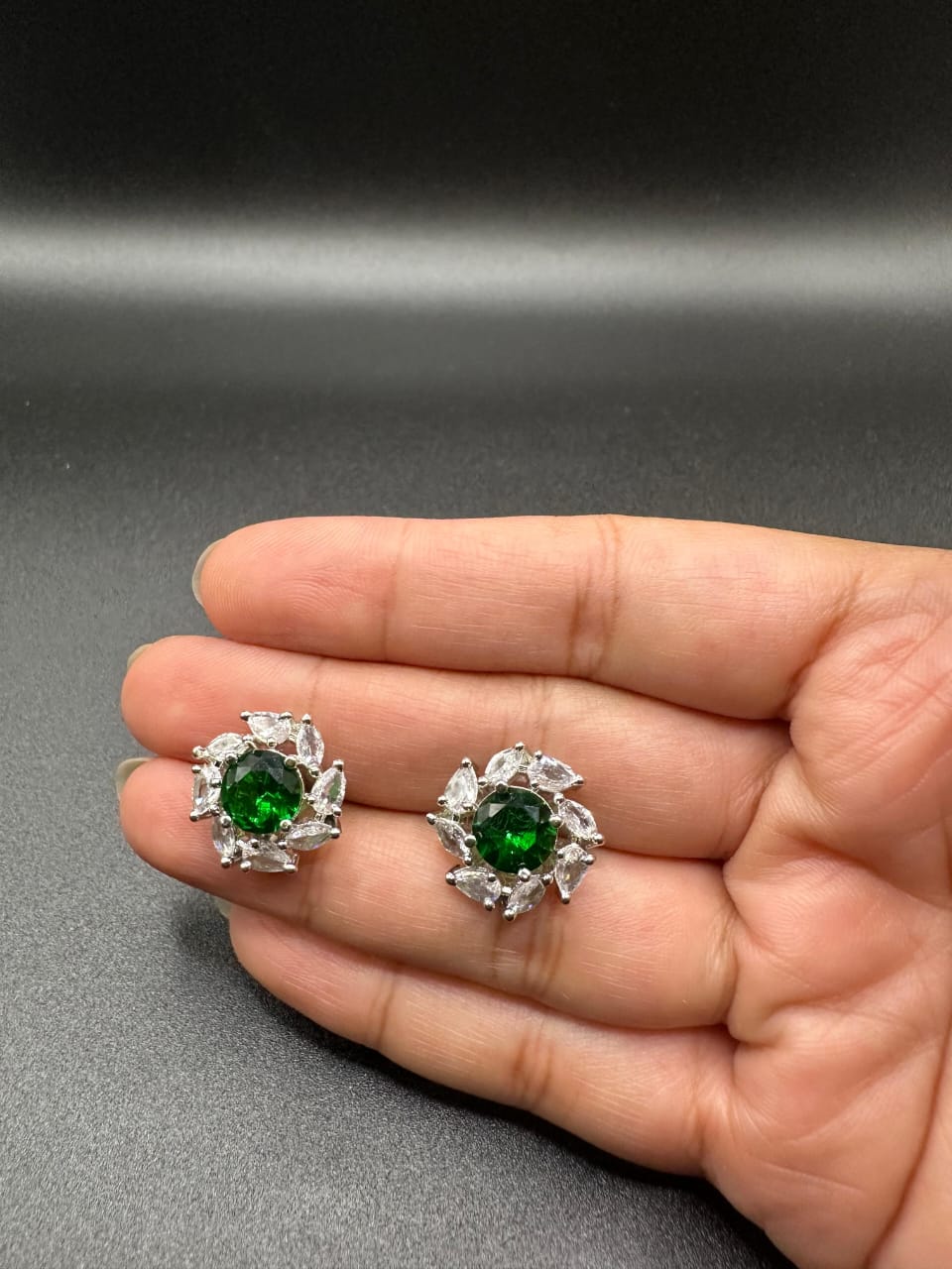 Diamond cut zircon studs with emerald inside