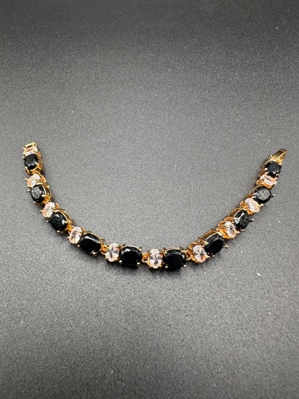 Black bracelet with golden base for girls