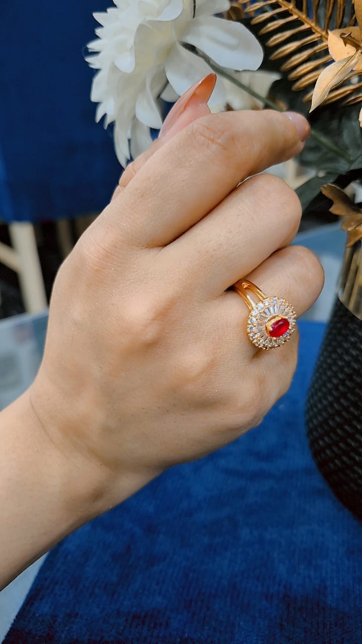 Golden adjustable ring with ruby inside