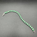 Emerald and zircon bracelet with silver base