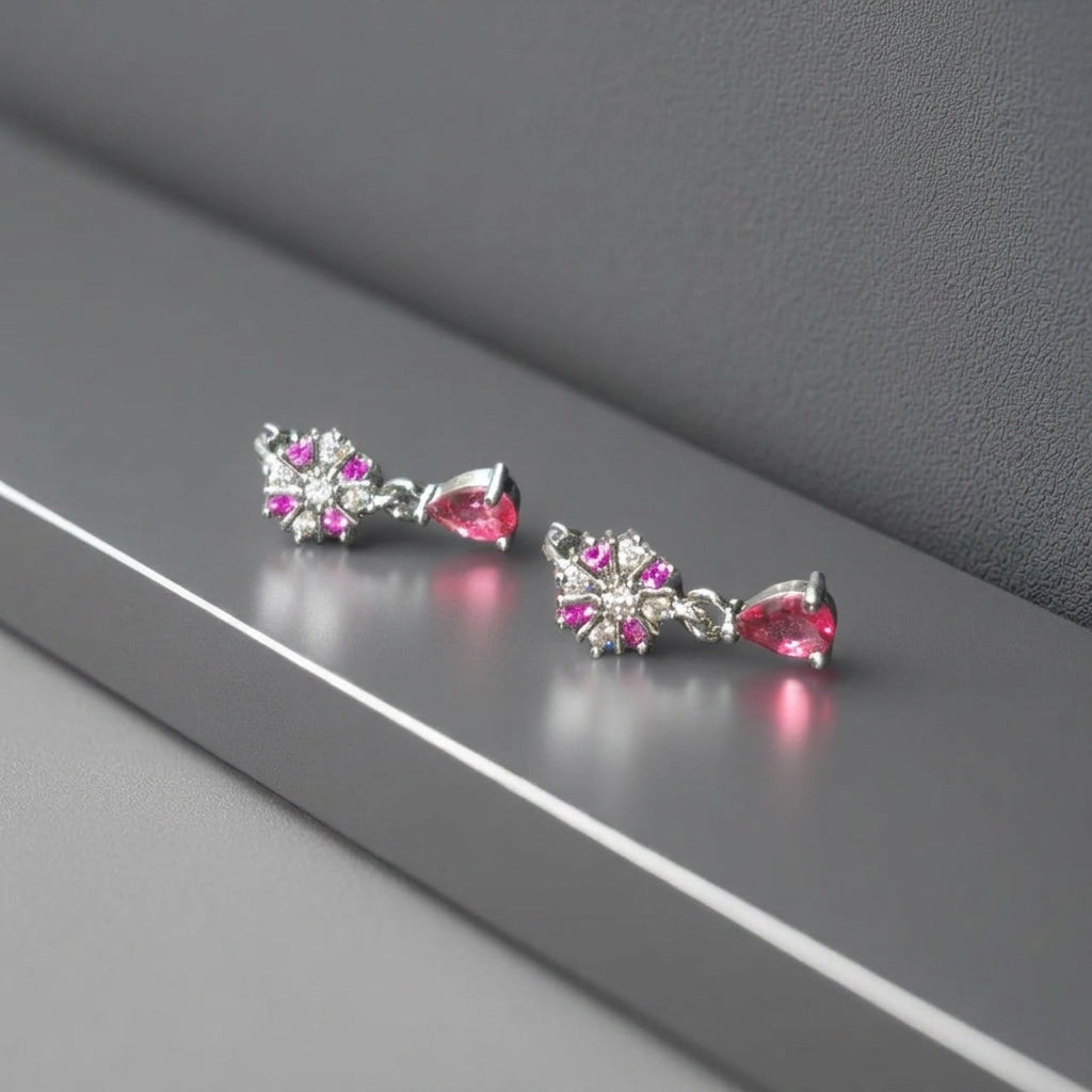 Dangle style silver earrings with pink stone