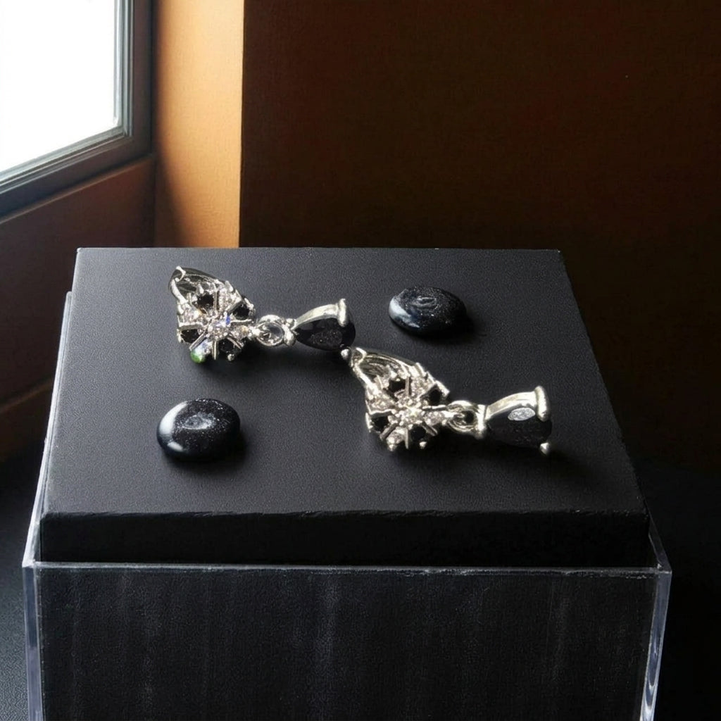 Dangle style silver earrings with black stone