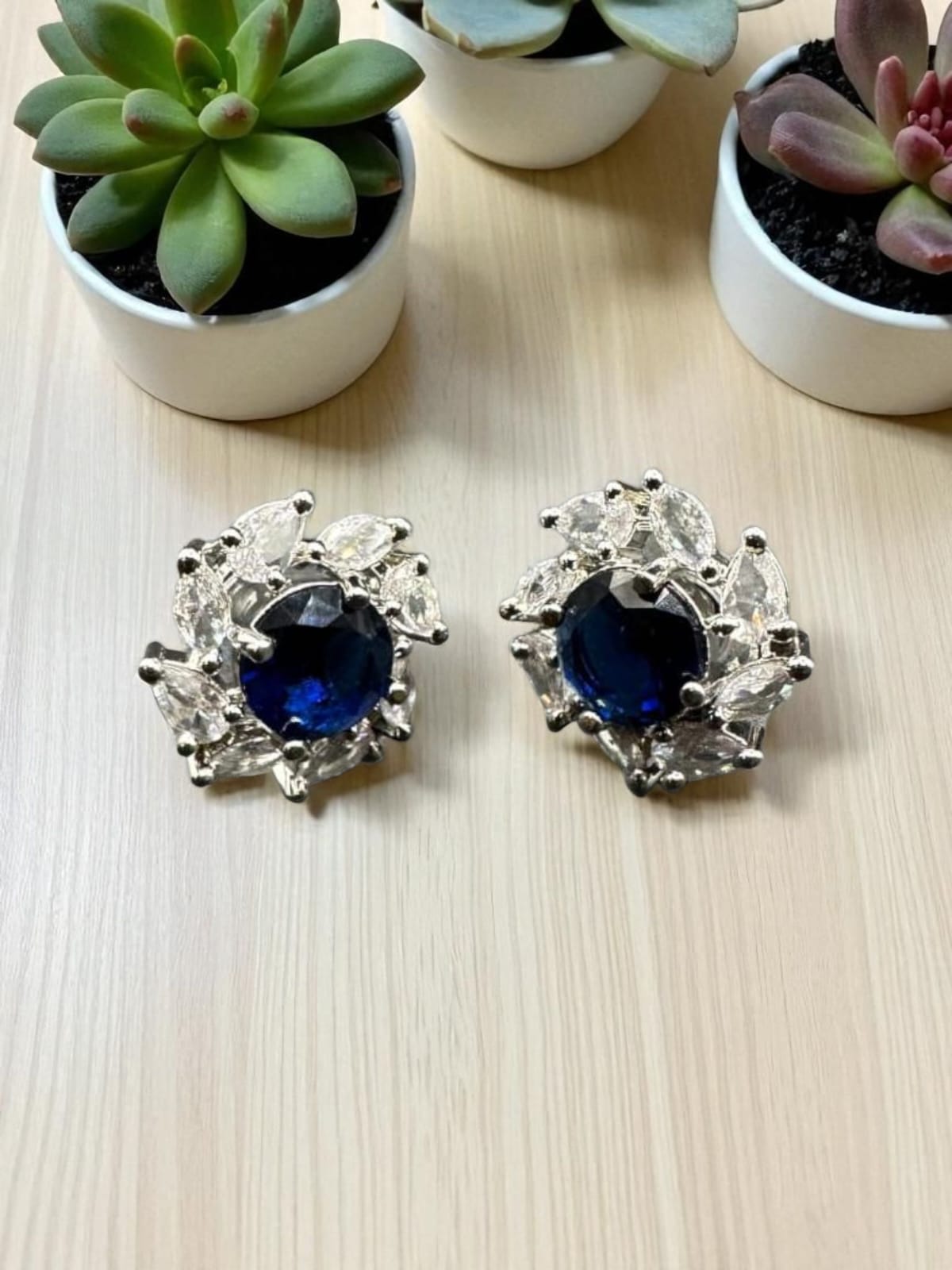 Diamond cut zircon studs with sapphire inside