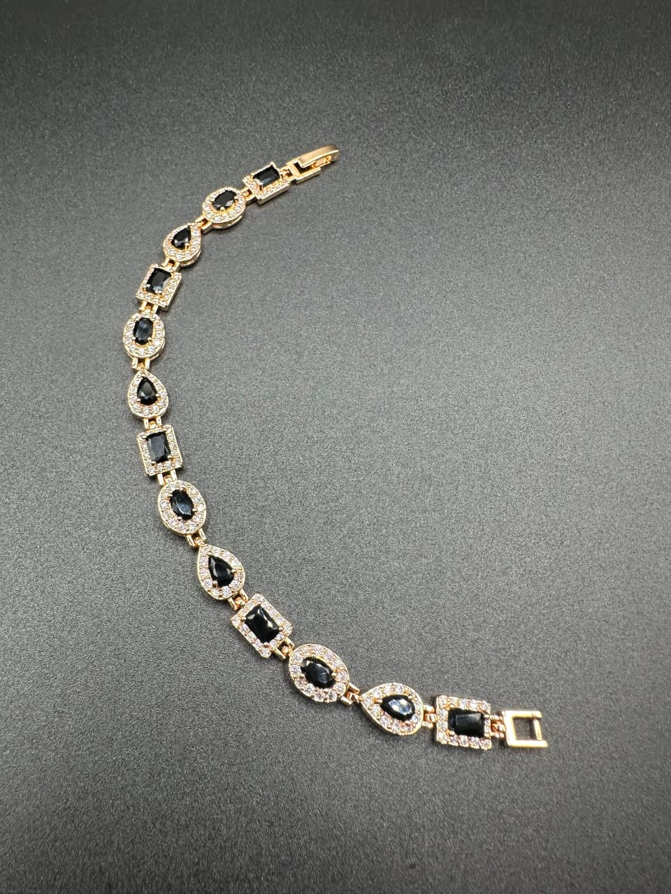 Black bracelet with golden base